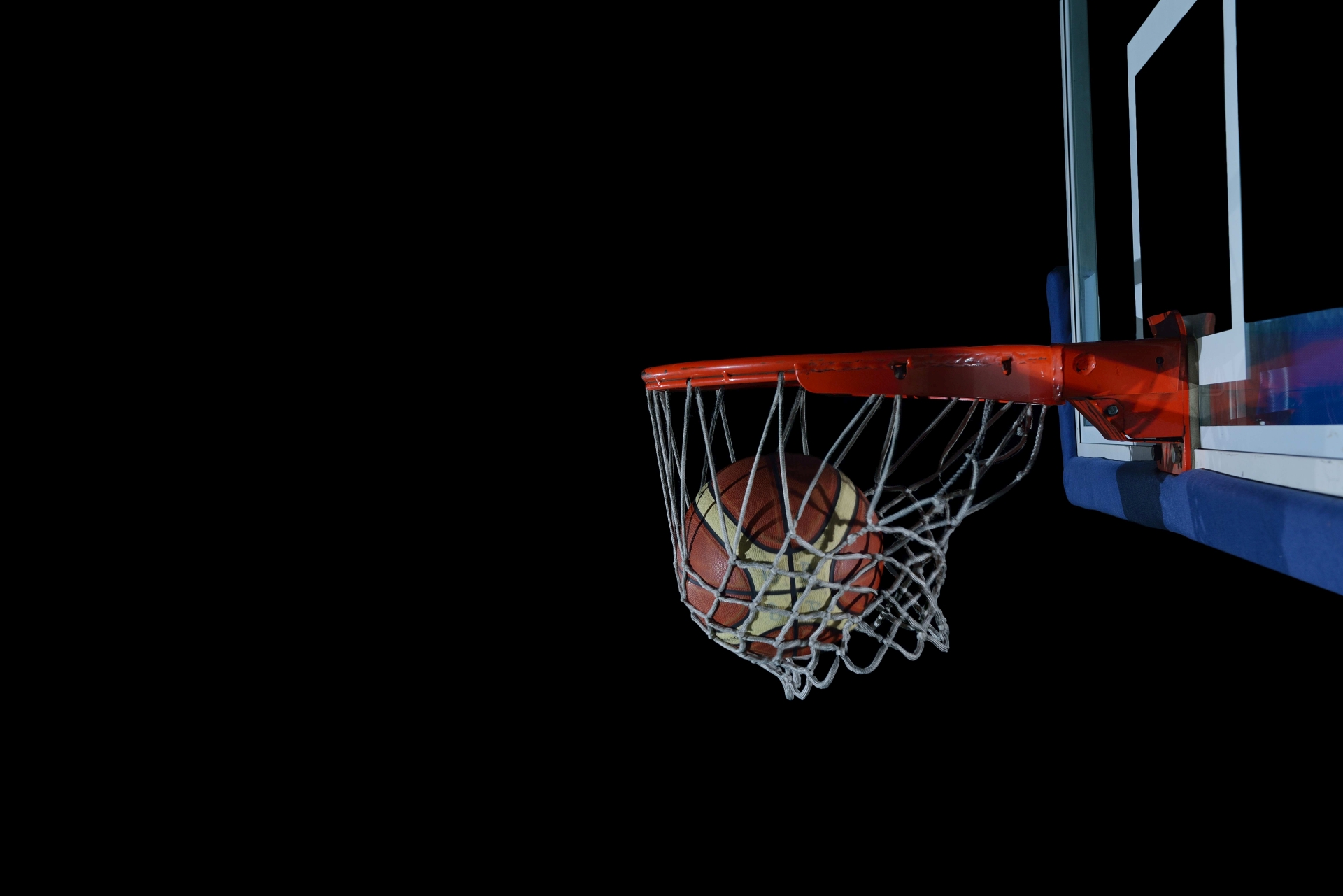 basketball ball and net on black background